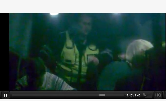 Kadras ia filmuotos medžiagos/Įvykio vietoje: per kontrolierių autobusiuką langą filmuota, kas vyksta salone.