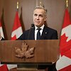 Markas Carney / DAVE CHAN / AFP