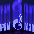 The company logo of Russian natural gas producer Gazprom is seen on an advertisement installed on the roof of a building in St. Petersburg in this November 14, 2013 file photo. As bankers, traders and investors gathered at Gazprom's London offices for its annual champagne reception, the message from
