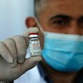 Palestinietis medikas su vakcinos nuo koronaviruso buteliuku
