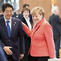 Shinzo Abe ir Angela Merkel