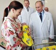 Septyniamilijardasis pasaulio žmogus, jo mama Jelena Nikolajeva ir Vladimiras Putinas