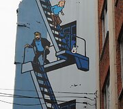 Komiksai &ndash; belgų kultūros dalis (pavaizduotas Tintinas su &scaron;unimi Sniegeliu)