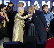 Princas Charlesas scenoje galanti&scaron;kai pabučiavo savo motinos karalienės Elizabeth II ranką.