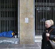 Benamis vyras guli prie Graikijos banko.