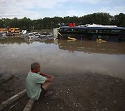 Vyras sėdi prie apsemto greitkelio