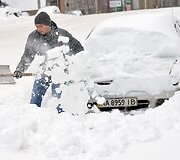 Vyras kasa sniegą.