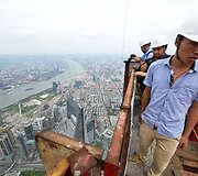 Žurnalistas ant statomo &Scaron;anchajaus dangoraižio vir&scaron;aus