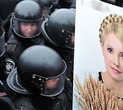 Julijos Tymo&scaron;enko portretas &scaron;alia raiu&scaron;ių policijos pareigūnų