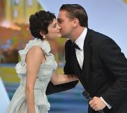 Leonardo DiCaprio (R) kisses on May 15, 2013 French actress and mistress of ceremonies at the Cannes Film Festival Audrey Tautou