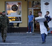 Picerijos darbuotojas atne&scaron;ė picą pabėgėliams laukiantiems prie sienos