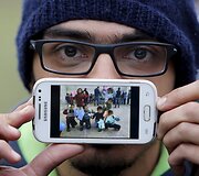 Migrantas Basas i&scaron; Damasko rodo nuotrauką vaikų mokykloje, kurioje savanoriavo
