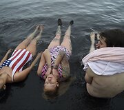 Turistai maudosi kar&scaron;tųjų versmių krateriniame ežere Desep&scaron;eno saloje Antarktidoje