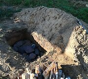 Archainiu būdu duobėje kepama mėsa