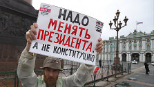 Protestuotojas laiko plakatą su užra&scaron;u: &bdquo;Reikia pakeisti prezidentą, o ne konstituciją&ldquo;