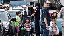 Atėnuose i&scaron;keldinami migrantai