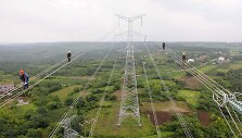 Darbininkai Kinijoje tikrina naujai nutiestą elektros liniją
