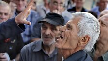 Graikas pensininkas ginčijasi su banko darbuotoju