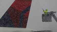 Nacionaliniame R.Reagano oro uoste nuo lėktuvų valomas ledas.