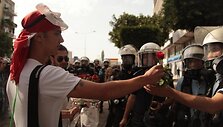 Protestors giving policemen flowers