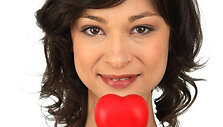 Brunette girl with heart in hand