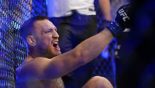 Conoras McGregoras ir Dustinas Poirier kovos ringe Las Vegase. Dvikova buvo nutraukta,  C.McGregorui patyrus čiurnos lūžį.