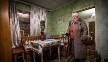 Marjinkos gyventoja Valentina Ivanova  stovi prie lentomis užkalto lango