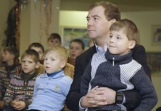 Dmitrijus Medvedevas su vaikais stebi pasirodymą.