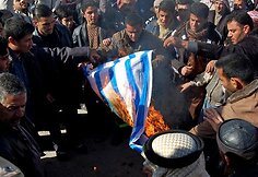 Irake vykusiame proteste prie&scaron; Gazos ruožo bombardavimą deginta Izraelio vėliava.