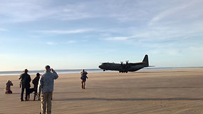 Netikėtai paplūdimyje nusileidęs didžiulis karinis lėktuvas nustebino susirinkusius