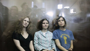 Members of the female punk band "Pussy Riot" (R-L) Nadezhda Tolokonnikova, Yekaterina Samutsevich and Maria Alyokhina sit in a glass-walled cage after a court hearing in Moscow, August 17, 2012. A judge sentenced three women who staged an anti-Kremlin protest on the altar of Moscow's main Russian Or