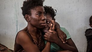 Dvi pabėgėlės i&scaron; Nigerijos verkia migrantų sulaikymo centre Libijoje