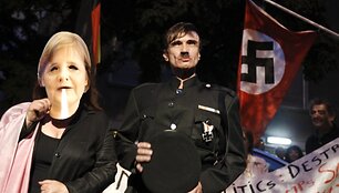 People role playing as Adolf Hitler (C) and German Chancellor Angela Merkel take part in a protest outside the German embassy in Athens October 6, 2011.