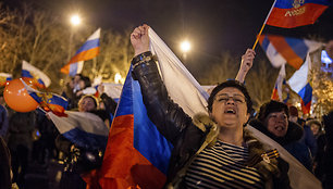 Pro-Russian people celebrate in the central square in Sevastopol, Ukraine, late Sunday, March 16, 2014. Russian flags fluttered above jubilant crowds Sunday after residents in Crimea voted overwhelmingly to secede from Ukraine and join Russia. The United States and Europe condemned the ballot as ill