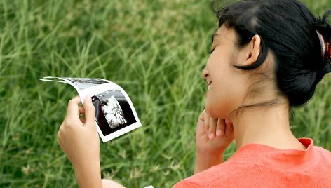 Būsima mama, žiūrinti į ultragarso nuotrauką