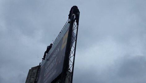 Kaune reklamas ant stendų darbininkai kabino be jokių apsaugų