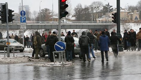 Automobilis ties Žveryno tiltu apsisuka. Kažkas minioje &scaron;ūkteli, kad tai Seimo automobilis ir įsiutę jaunuoliai bėga automobilio link.