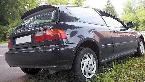 Automobiliai statomi ant žalio vejos.