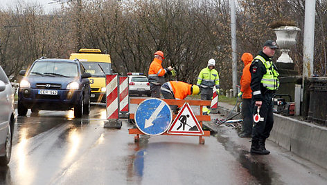 Policija ant tilto reguliuoja eismą.