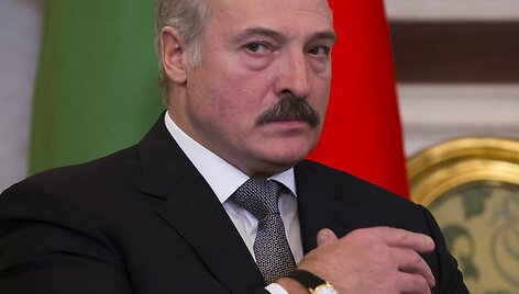 Belarus' President Alexander Lukashenko looks at the media as he listens to Russian President Vladimir Putin during their meeting in Moscow's Kremlin, Russia, Wednesday, Dec. 25, 2013. The two ex-Soviet neighbors signed agreements on military-technical cooperation and information security following 