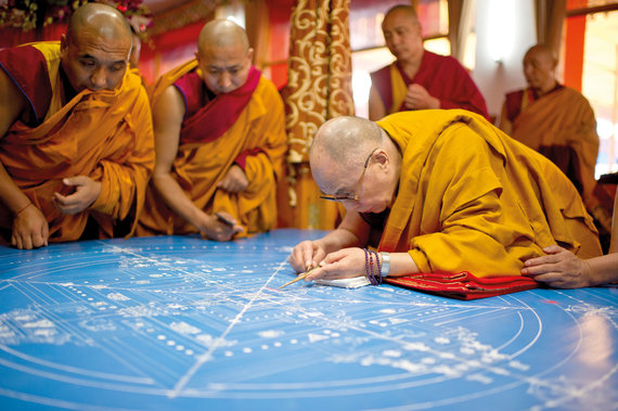 Leidyklos nuotr./14. Dalai Lama beria pirmasias splavoto smelio smilteles, pradedama sudetinga mandala © Jo Šventenybės Dalai Lamos administracija