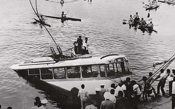 A sunken trolleybus is pulled out of the lake