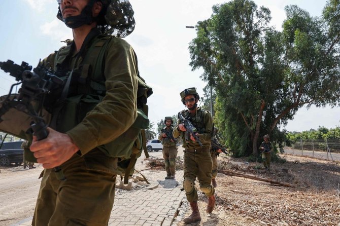 AFP/„Scanpix“ nuotr./Izraelio kariai netoli Gazos Ruožo