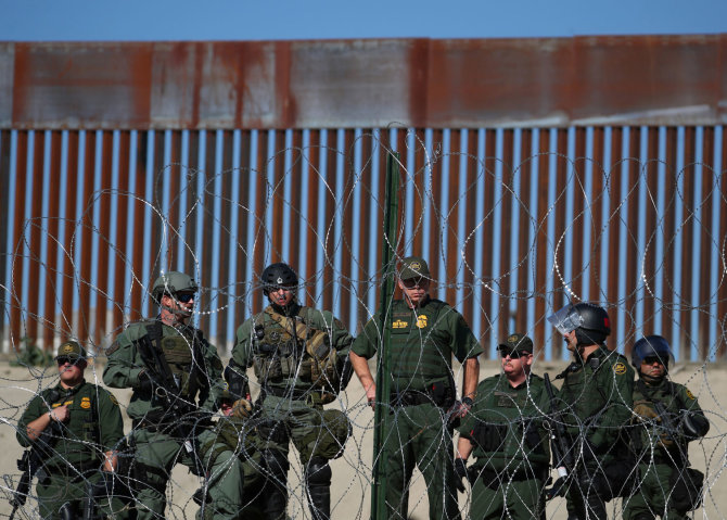 „Reuters“/„Scanpix“ nuotr./JAV pasieniečiai prie tvoros palei Amerikos ir Meksikos sieną