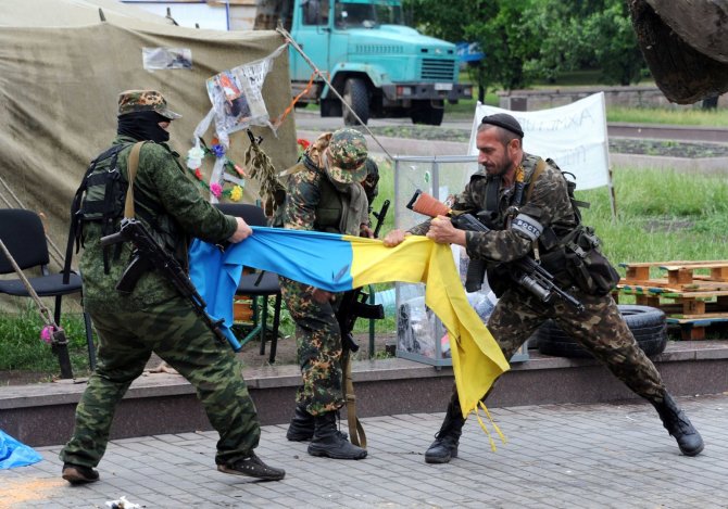 AFP/„Scanpix“ nuotr./Prorusiški teroristai plėšo Ukrainos vėliavą Donecke