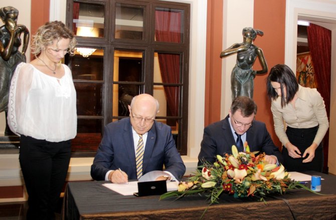 Uosto kompanijos nuotr./Aloyzas Kuzmarskis (kairėje) ir Tomas Juočys pasirašo sutartį.