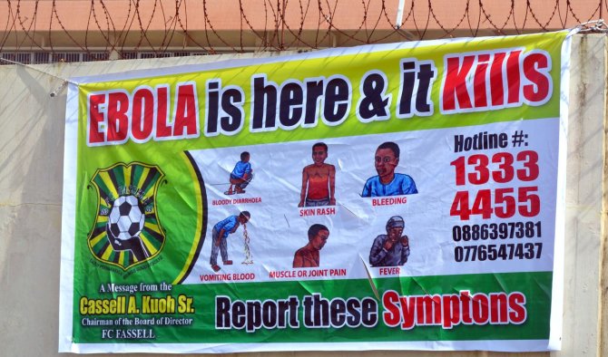 AFP/„Scanpix“ nuotr./Apie Ebolos viruso grėsmę perspėjantis plakatas Liberijoje