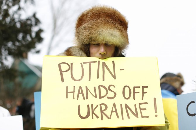 „Reuters“/„Scanpix“ nuotr./Plakatas, skirtas V.Putinui
