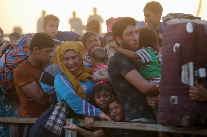„Reuters“/„Scanpix“ nuotr./Pabėgeliai iš Ramadžio miesto Irake
