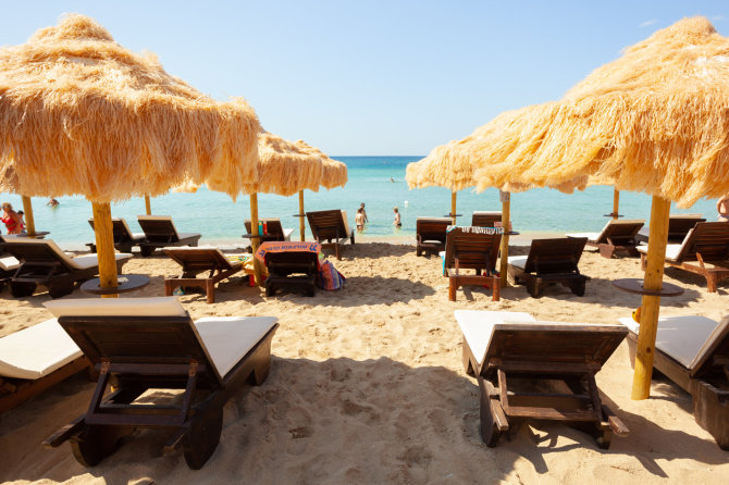 123rf.com nuotr./Beach beautiful thatched umbrellas and turquoise sea.